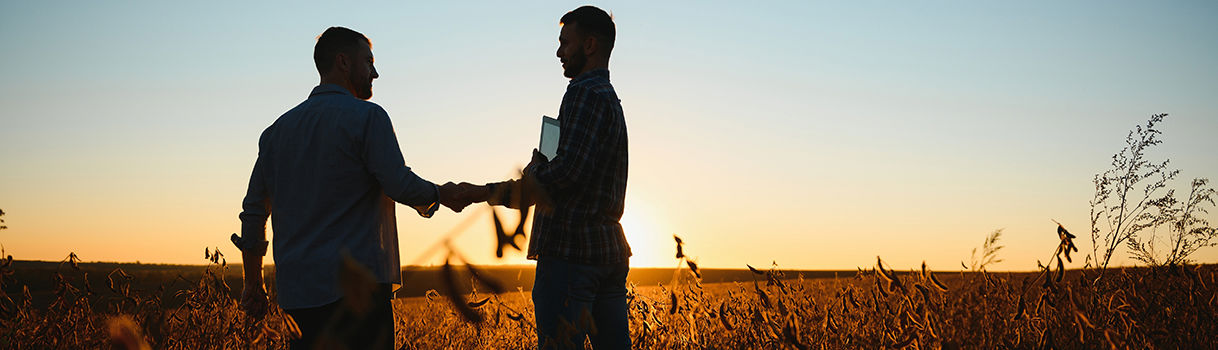 Clear Sustainable, Clear Future, Sustainable, two businessmen in a field shaking hands